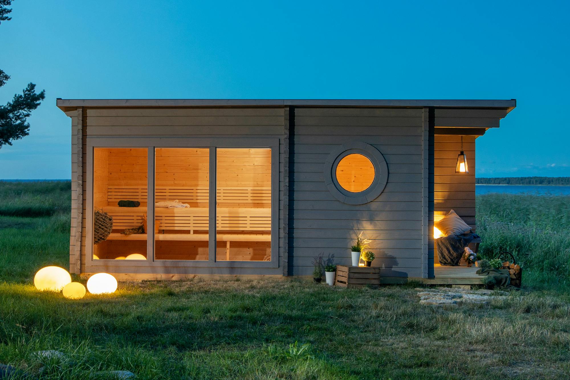 Nordic Grey Cabin Sauna with Patio, Outdoor Sauna with Full Glass Facade and Round Windows Door and glass