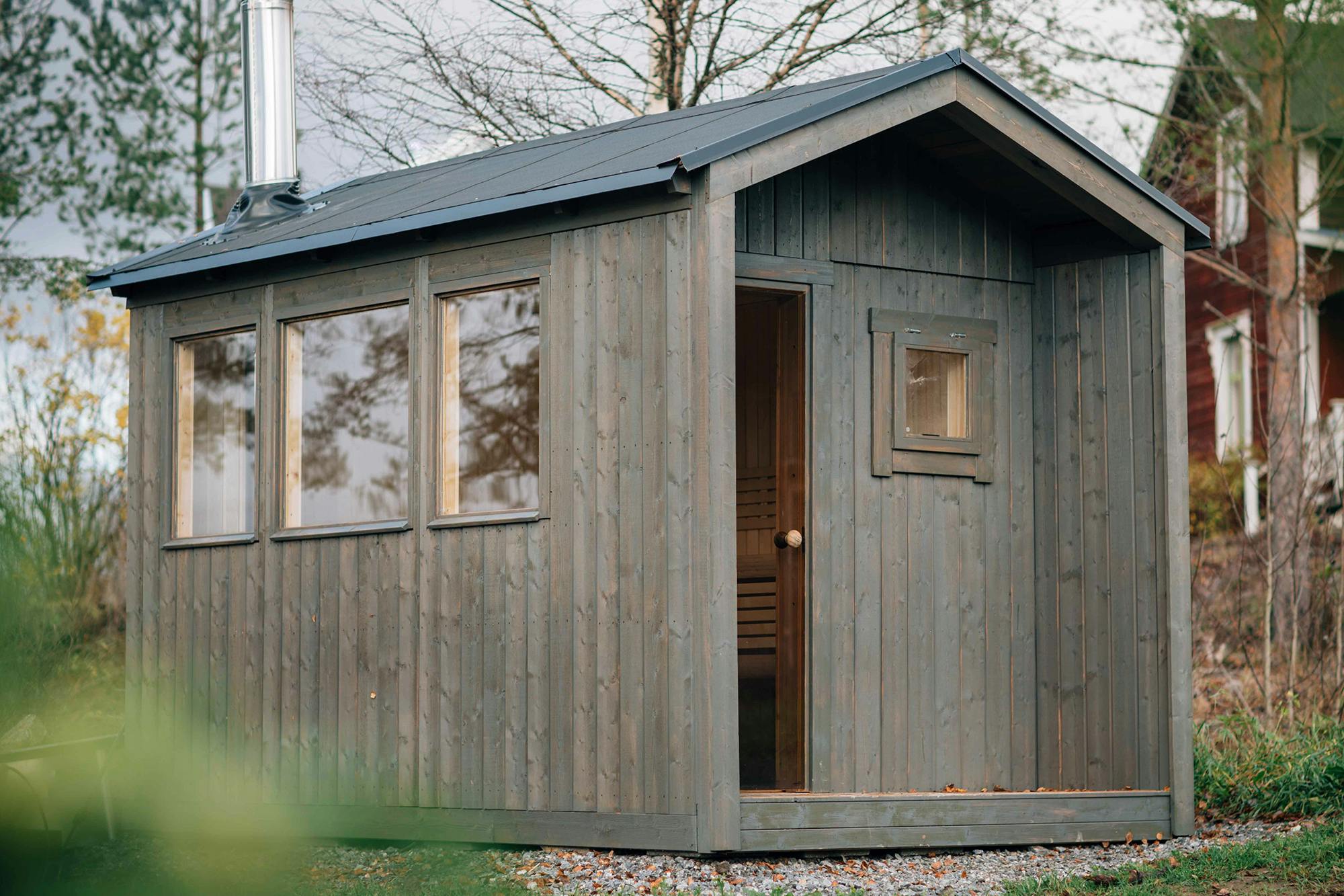 Nordic Style Outdoor Sauna Cabin, Grey Wood Sauna House with Traditional Wood Stove Setup Interior detail