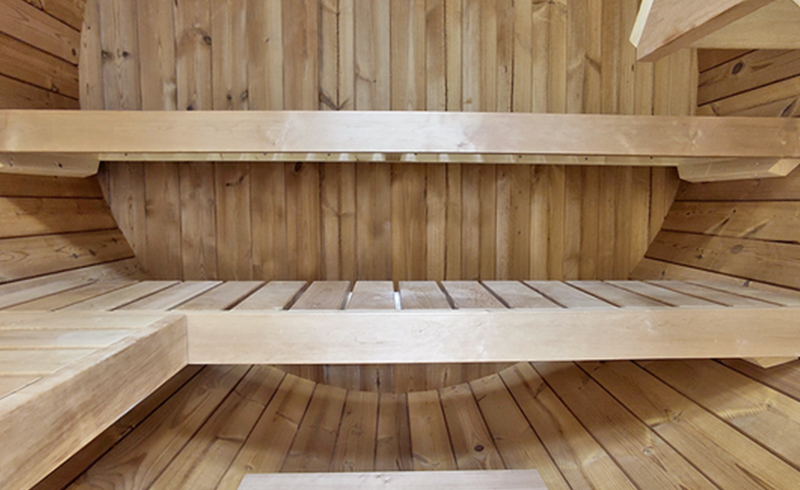 Red Cedar Outdoor Barrel Sauna with Glass-Front Option interior curved bench layout